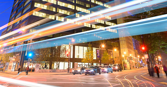 Street view of 100 Peachtree Street with street lights and cars