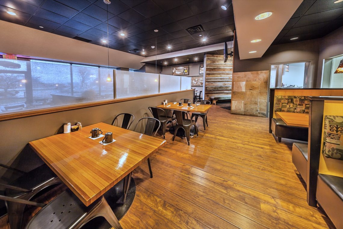 Cozy tables and booth seating in the full service Sunrise Cafe located in the Meridian Mark II building