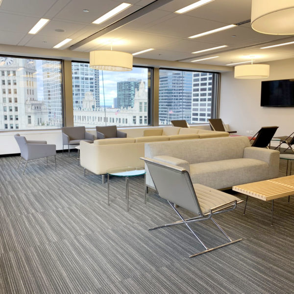 A meeting room with sofas and television at Zeller managed 401 N. Michigan Avenue.