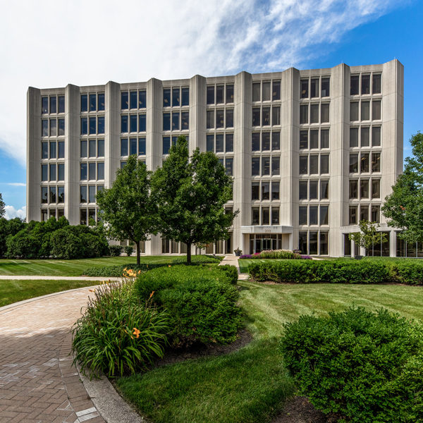 Grass, trees and front door of Zeller's Commerce Plaza office building in Oak Brook.