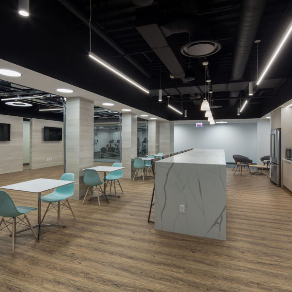 The tenant center kitchen and break area with tables and chairs located in the Zeller managed Commerce Plaza office building.