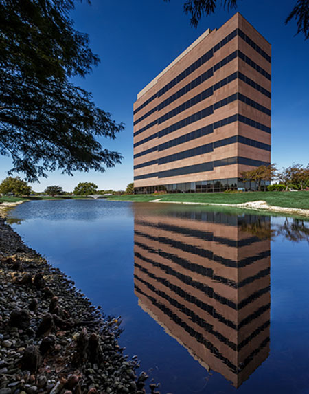 The entire Meridian Mark II office building in Carmel, IN, managed by Zeller and the reflecting pool.