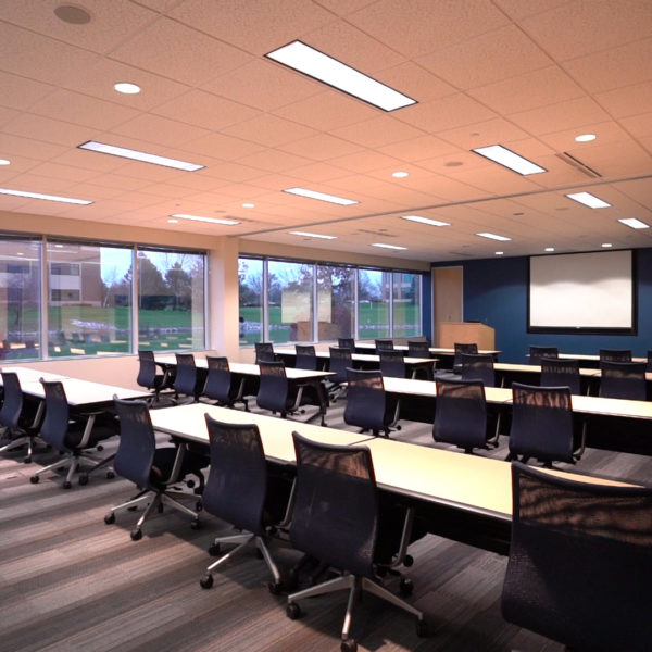 Conference room with tables and chairs at Riverwood Corporate Center in Pewaukee, WI.