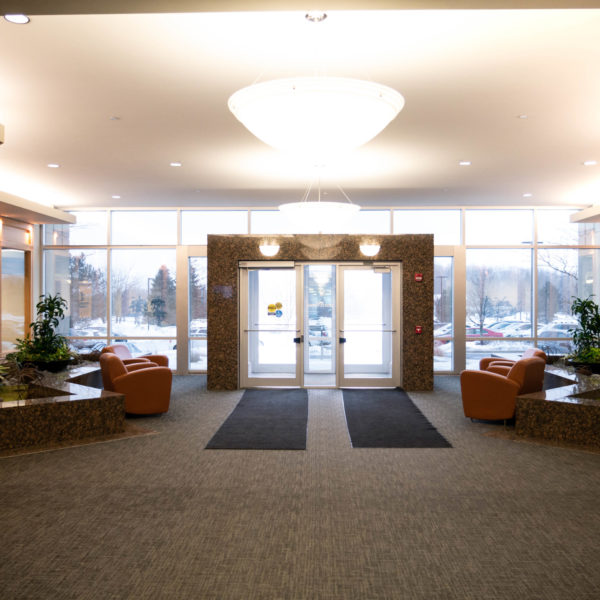 The lobby and front doors of the Riverwood Corporate Center managed by Zeller and located in Pewaukee, WI.