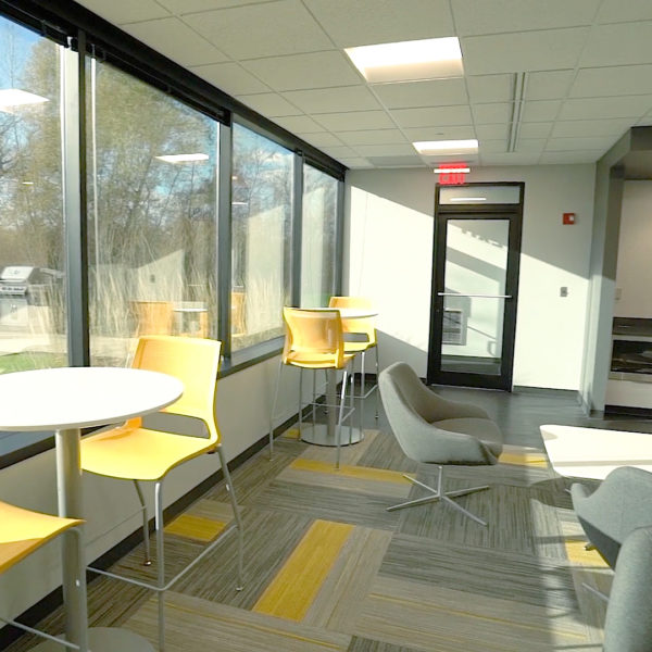 Chairs and tables in a lounge area in the Riverwood Corporate Center in Pewaukee, WI, lounge area.