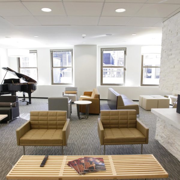 A tenant lounge area with chairs, tables and a piano inside the historic Wrigley Building in Chicago, scaled.